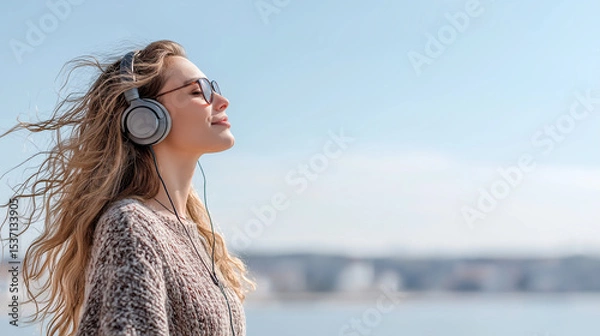 Obraz Woman listening to music and relaxing outside in warm sunny spring day
