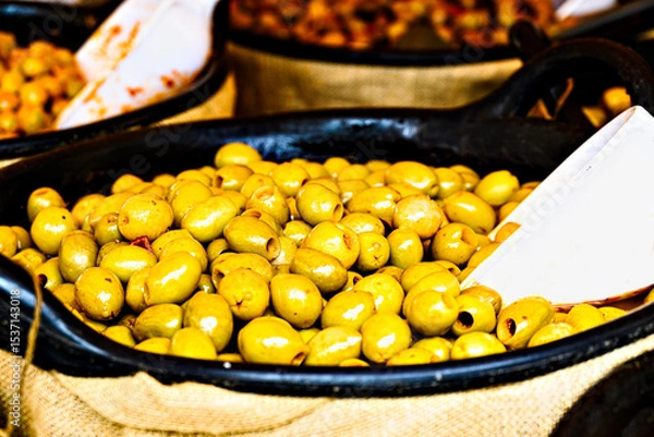 Obraz Container with fresh and delicious green olives	