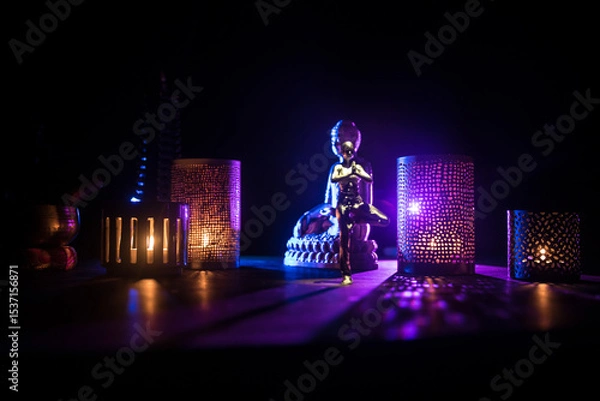 Fototapeta Yoga Concept with Namaste Statue and Oriental-Inspired Miniature on Table