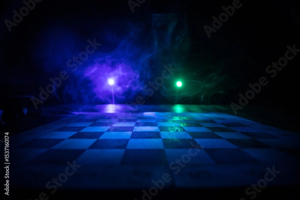 Fototapeta Chess board game concept of business ideas and competition. Chess figures on a dark background with smoke and fog.
