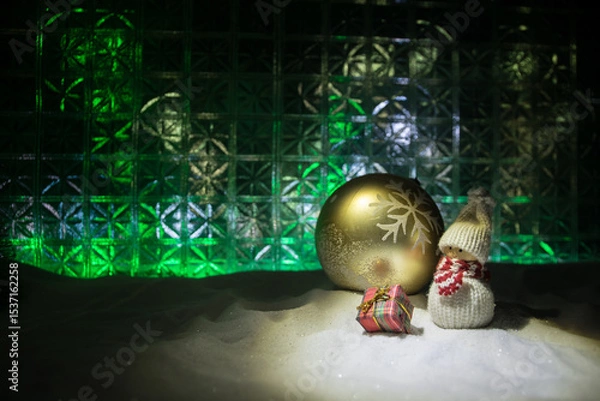 Fototapeta Christmas home decoration with snow and tree on a dark background with copy space. Selective focus. New Year attributes on background