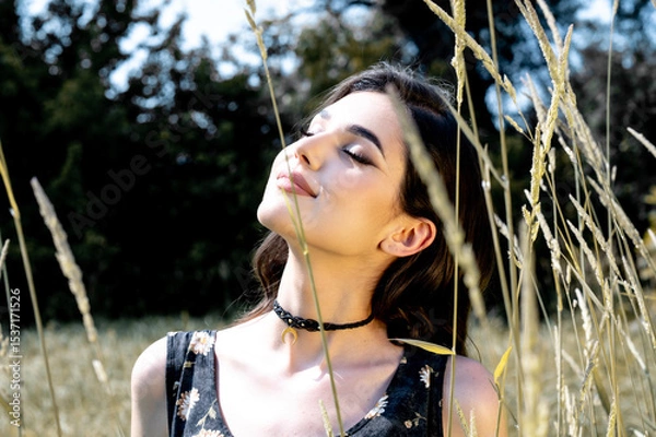 Fototapeta Brunette female 19 years old posing outdoor as fashion model