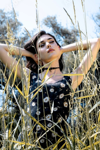 Fototapeta Brunette female 19 years old posing outdoor as fashion model