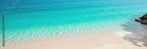 Fototapeta Serene turquoise water gently laps a tranquil shoreline, creating a calming atmosphere Perfect for relaxation and meditation themes , gentle, escape, clean