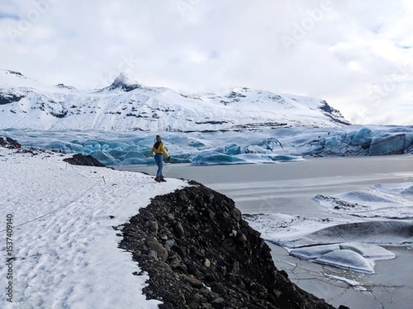 Obraz Woman standing in wide open icy winter wonderland, Iceland