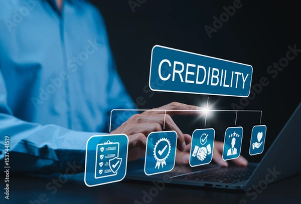 Obraz Credibility and trust in business concept. Businessman using laptop with icons credibility, trust, reputation, verification, integrity, reliable, authentic, commitment, regard, and quality assurance.