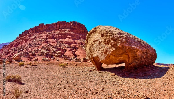 Fototapeta Balanced Boulder and Rugged Mesa in Desert Wilderness Eye Level Panorama