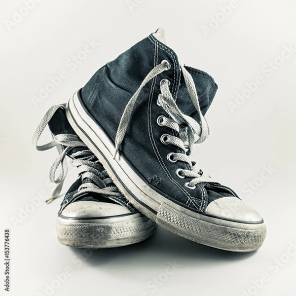 Obraz Old and worn pair of sneakers with white background