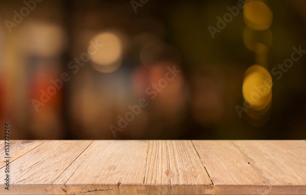 Fototapeta Empty wood table top and blur of restaurant background selective focus product display