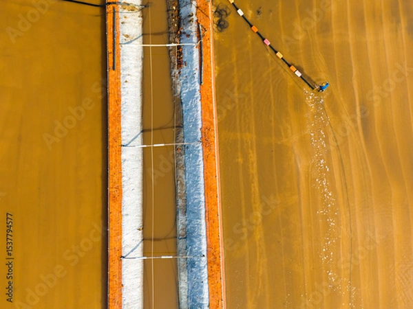 Obraz Salt-farm workers produce salt in the salt fields， salt-farm equipment produces salt
