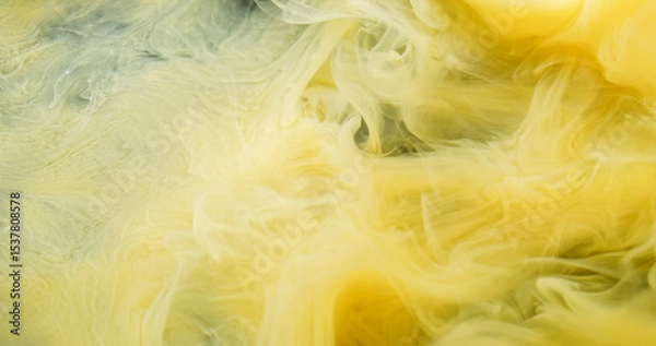 Fototapeta Color vapor. Ink shot. Yellow curl pigment underwater dissolve. Haze liquid bright spray on wet background abstract defocused flow.