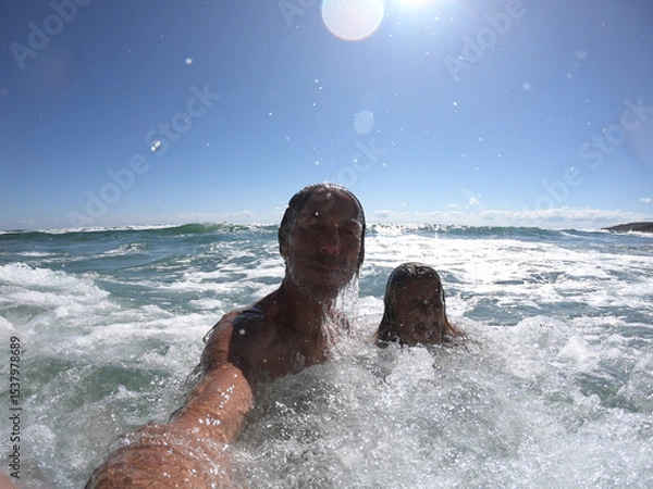 Obraz Sea waves splashing on happy couple.