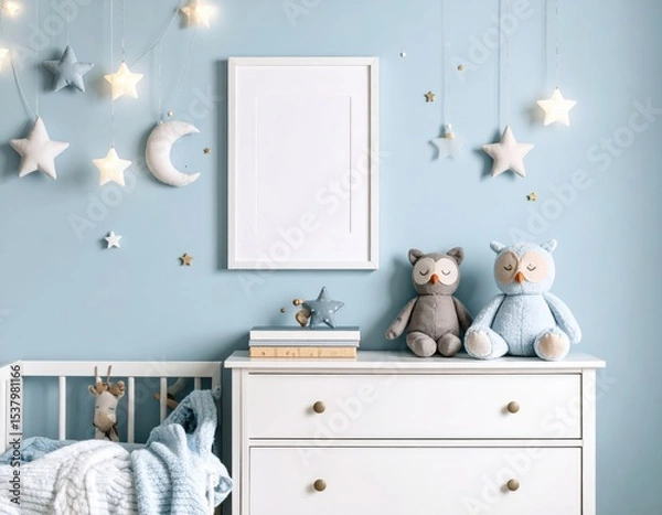 Fototapeta Serene nursery scene with plush owls star lights and a blank frame on a blue wall
