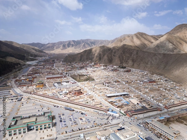 Fototapeta Xiahe, China: Aerial view of the Tibetan Buddhism Labrang Monastery surrounded by a 3km long prayer wheel circuit  in the Xiahe town in the Amdo region of Gansu province on the Tibetan plateau