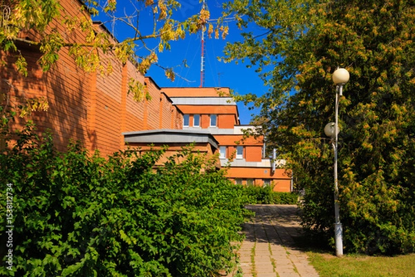 Obraz Cityscape on a summer day, modern buildings and houses against the blue sky 