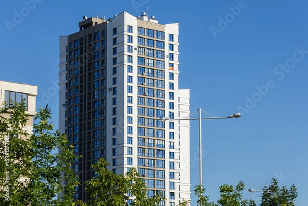 Obraz Cityscape on a summer day, modern buildings and houses against the blue sky 