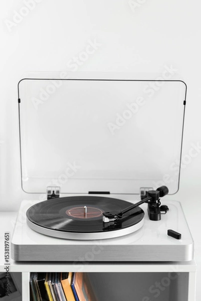 Fototapeta Close-up of a vinyl record playing on a modern turntable. Stylish and minimalistic.