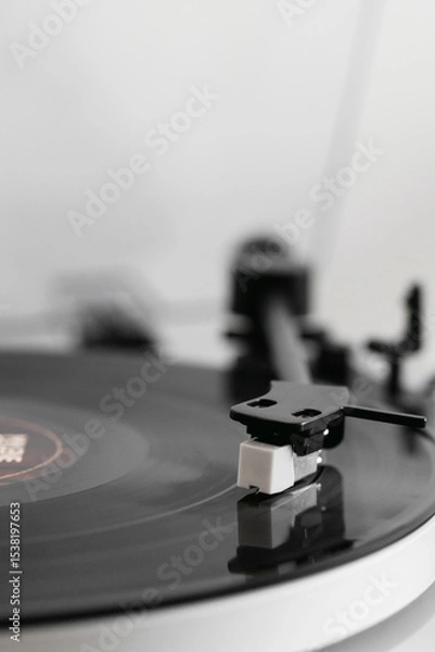 Fototapeta Close-up of a vinyl record playing on a modern turntable. Stylish and minimalistic.