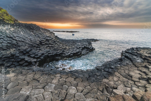 Fototapeta Da Dia reef or Ganh Da Dia in Phu Yen in Vietnam at sunrise. Landscape with volcanic basalt columns on rocky beach by the sea