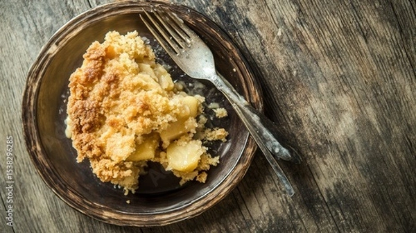 Fototapeta Aromatic Apple Crumble: A Rustic Delight. Indulge in the sweet and crumbly goodness of this classic dessert, captured in a mouthwatering close-up. The perfect autumn treat!