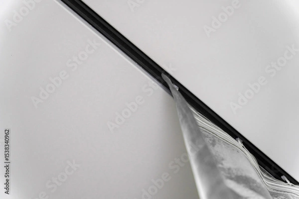 Obraz Close-up of the silver curtain hanging from the ceiling rail in the bathroom, creating a stylish and modern atmosphere.