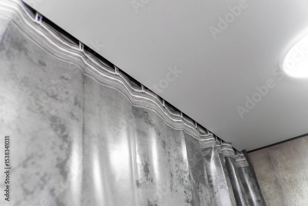Obraz Modern gray curtains are hanging from a ceiling track system, adding a touch of elegance and style to the interior design of a contemporary apartment