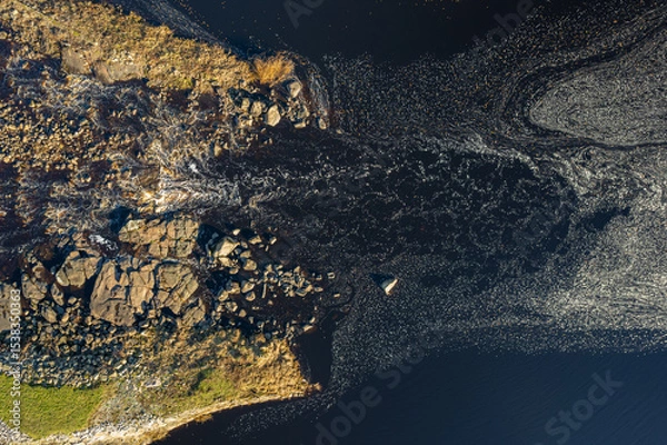 Fototapeta Beautiful foam patterns on water surface in river or sea, aerial drone view