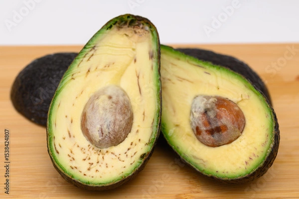 Obraz Rotten avocado unfit for consumption, cut in half, not fresh