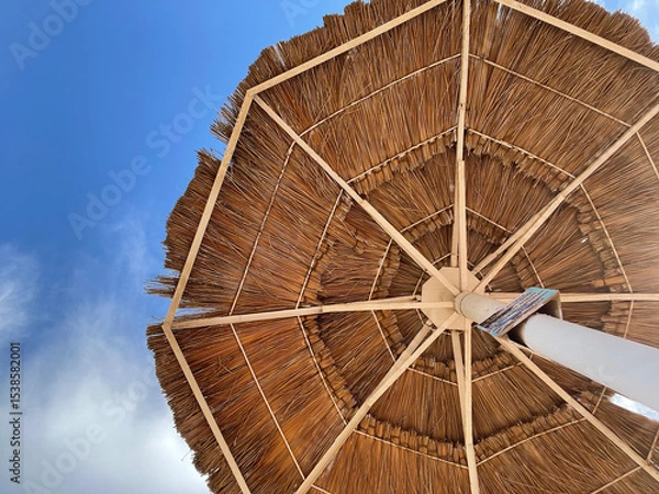 Obraz Straw Beach Umbrella Against Blue Sky