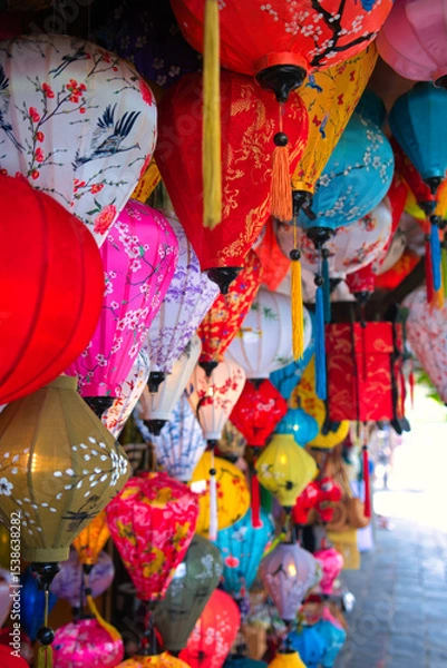 Fototapeta Hoi An, Vietnam October 28, 2023. Old buildings with the river in Hoi An, Vietnam. The historic old town of Hoi An is UNESCO World Heritage Site since 1999. This was during a hot day in wet season.