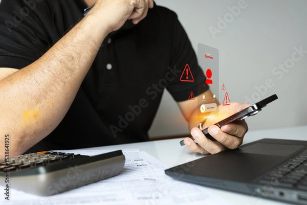 Obraz Man receiving scam call with cyber threat alert icons on smartphone screen in office environment