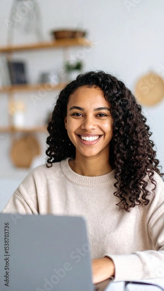 Fototapeta Happy young woman using laptop sitting at desk writing notes while watching webinar, studying online, looking at pc screen learning web classes or having virtual call meeting remote working from home.
