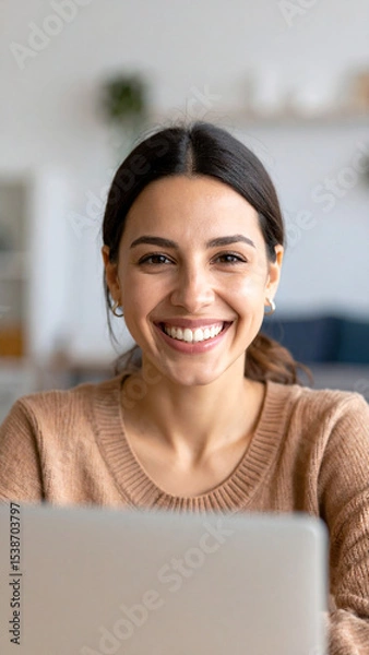 Fototapeta Happy young woman using laptop sitting at desk writing notes while watching webinar, studying online, looking at pc screen learning web classes or having virtual call meeting remote working from home.