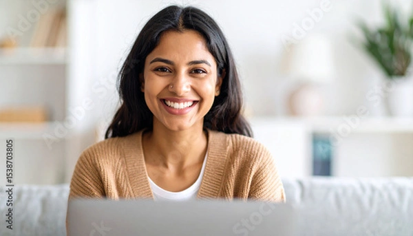 Fototapeta Happy young woman using laptop sitting at desk writing notes while watching webinar, studying online, looking at pc screen learning web classes or having virtual call meeting remote working from home.