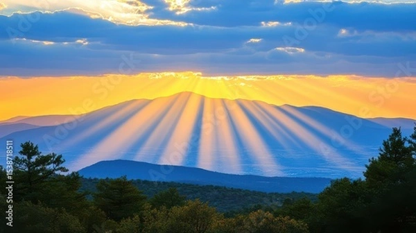 Obraz Golden Sunbeams Break Through Clouds Over Serene Mountain Valley