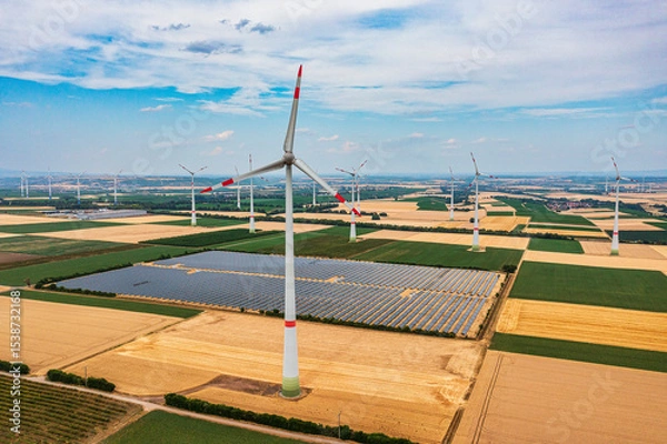 Fototapeta A bird's-eye view of grain fields and a wind farm with a solar field in Rheinhessen
