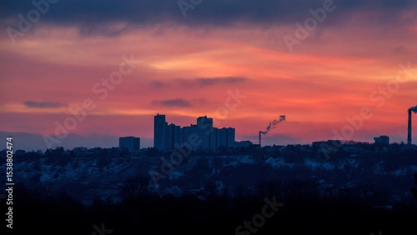 Obraz Silhouette of constructing buildings against amazing sunset red sky.