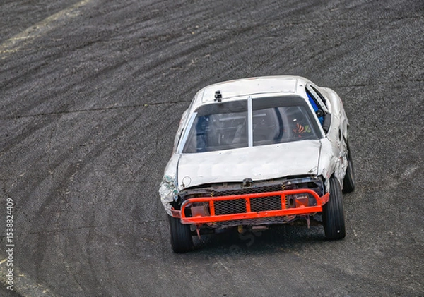 Fototapeta 2025-06-14 A WHITE RACE CAR WITH A ORANGE BUMBER ENTERING A CORNER AT THE RACE TRACK AT THE EVERGREEN STATE FAIRGROUNDS IN MONROE WASHINGTON