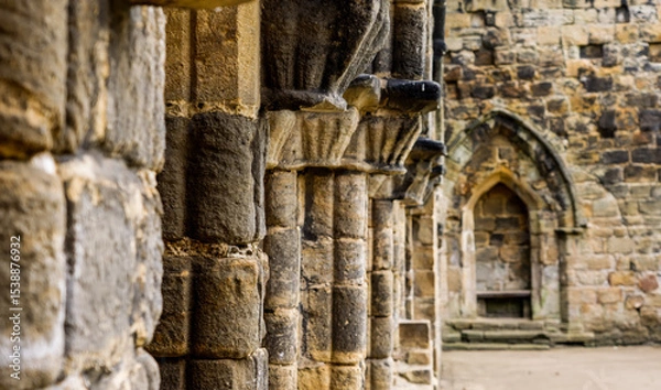 Fototapeta Architectural details showing weathered stone columns and arches in the ruins of Kirkstall Abbey, a cistercian monastery in Leeds, West Yorkshire, England