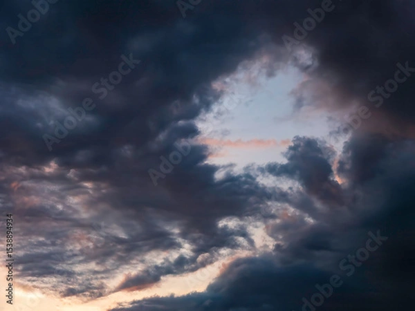 Obraz Dramatic gap in a dark cloud at sunset in southwest Florida, for background or element with motifs of air currents, changeability in nature, transitions and transformation