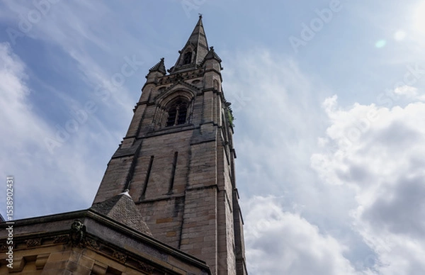 Fototapeta Majestic architecture of St. Nicholas Cathedral in Newcastle, UK, standing tall against a backdrop of cloudy sky