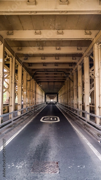Fototapeta Road going under the Tyne Bridge with speed limit sign showing twenty miles per hour