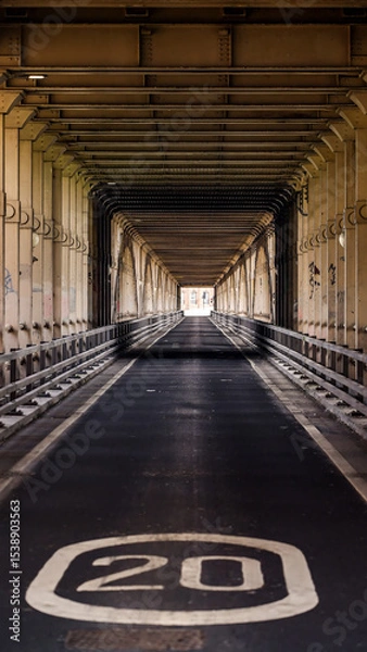 Fototapeta Road going under Tyne Bridge in Newcastle upon Tyne, UK, showing a speed limit sign
