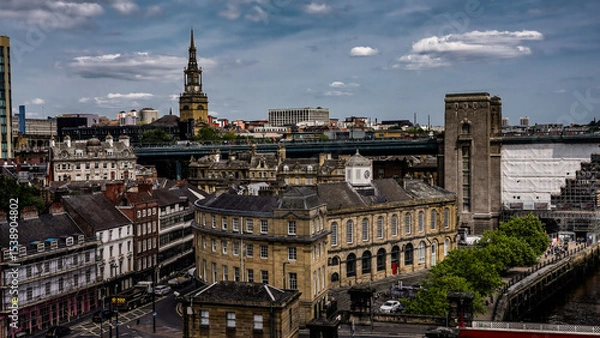 Fototapeta Newcastle upon Tyne cityscape showing All Saints' Church, Tyne Bridge and the Guildhall on a cloudy day