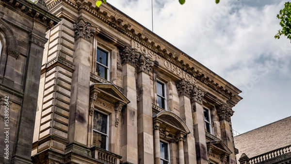 Fototapeta Architectural detail of the historic Post Office building in Newcastle upon Tyne, showcasing ornate stonework and large windows