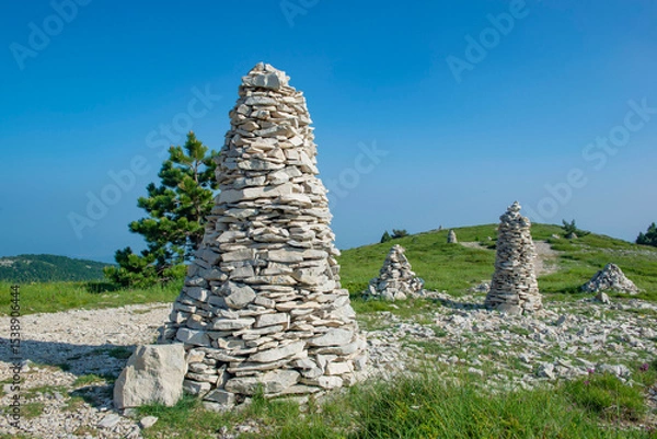 Fototapeta large mountain cairns iat the edge of a path n a beautiful landscape under blue sky in the Lure mountain in the Vaucluse in France