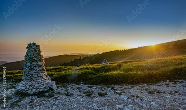 Fototapeta a large mountain cairn in a beautiful landscape during a sunset  in colorful sky in the Lure mountain in the Vaucluse in France
