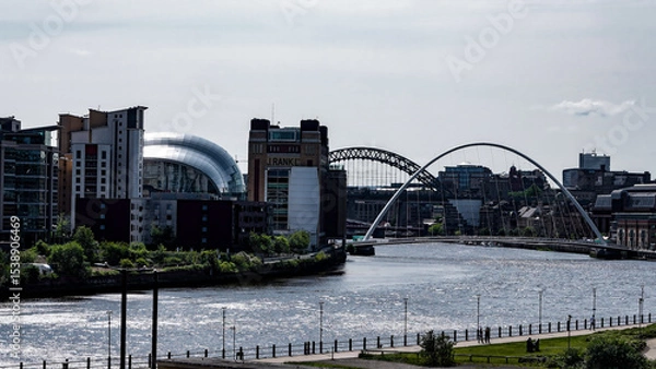Fototapeta Modern and historical architecture blend seamlessly along the River Tyne in Newcastle, UK