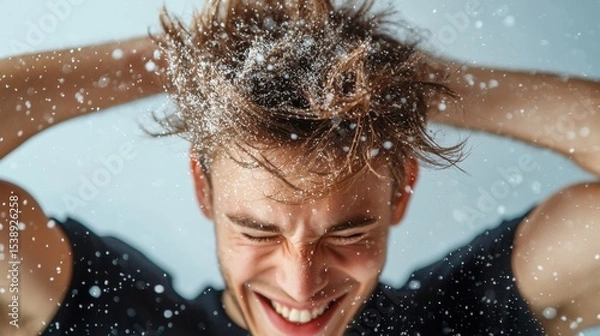 Obraz Close-up of a person shaking their head, causing dandruff flakes to fall from their hair onto a plain background