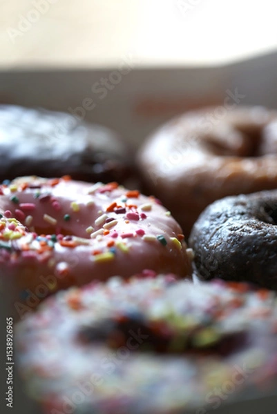 Fototapeta A top down view of multiple donuts.
